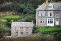 Grassy hills with houses on top in Port Isaac, Cornwall, England. Royalty Free Stock Photo