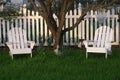 Grassy Lawn and White Lawn Chairs and Picket Fence