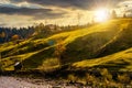 Grassy rural hillside near the village at sunset