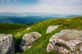 Grassy slope of a hill with huge boulders Royalty Free Stock Photo