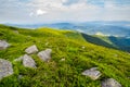 Grassy slope with huge rocks Royalty Free Stock Photo