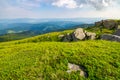 Grassy slope with huge rocks Royalty Free Stock Photo