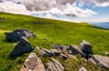 Grassy slopes with huge rocks Royalty Free Stock Photo