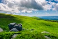 Grassy slopes with huge rocks Royalty Free Stock Photo