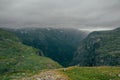 grassy slopes of rocks during foggy weather, Norway, Hardangervidda Royalty Free Stock Photo