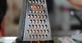 Grate carrot on a grater close up