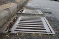 Grate of a storm sewer drain up close perspective