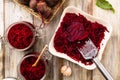 Grated beetroot marinated in jars. Wooden background