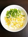 grated boiled egg and green onions in a bowl Royalty Free Stock Photo