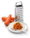 Grated carrot salad and grater Royalty Free Stock Photo