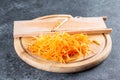 Grated carrots for making a spicy salad with bell peppers, carrots, vegetables and sesame seeds. Step by step recipe Royalty Free Stock Photo