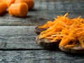 Grated carrots on a wooden rustic background Copy space