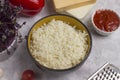 Grated cauliflower in a deep plate. Cauliflower keto pizza dough making process