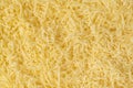 Grated cheese background texture. yellow shredded  cheese. Close up top view Royalty Free Stock Photo