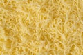 Grated cheese background texture. yellow shredded  cheese. Close up top view Royalty Free Stock Photo