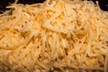 Grated grated cheeseDelicious grated cheese on a coarse grater close-up Royalty Free Stock Photo