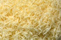 Grated cheese close-up top view, cheese on a coarse grater Royalty Free Stock Photo