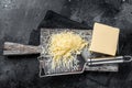 Grated cheese for cooking on a cutting board . Black background. Top view Royalty Free Stock Photo