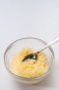 Grated cheese in a crystal bowl with spoon Royalty Free Stock Photo