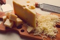 Grated cheese, Maasdam, on a cutting board, grater and cheese knife, close-up, no people,