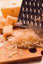 Grated cheese, Maasdam, on a cutting board, grater and cheese knife, close-up, no people,