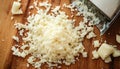 Grated cheese on wooden cutting board Royalty Free Stock Photo