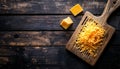 Grated cheese on wooden cutting board Royalty Free Stock Photo