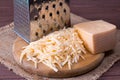 Grated cheese on a wooden cutting board Royalty Free Stock Photo