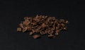 Grated chocolate. Heap of ground chocolate isolated on black background, closeup Royalty Free Stock Photo