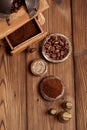 Grated coffee in old iron weights and wooden background