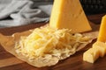 Grated and cut delicious cheese on board Royalty Free Stock Photo