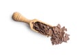 Grated dark chocolate in wooden scoop. Chocolate flakes isolated on white background