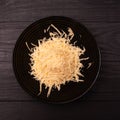 Grated hard cheese on a dark background