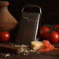 grated hard cheese Grated cheese and grater and fresh ripe tomatoes.