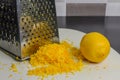 Grated lemon zest on a metal grater Royalty Free Stock Photo