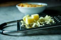 Grated Parmesan cheese, Cheese grater with cheddar Royalty Free Stock Photo