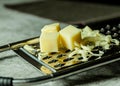 Grated Parmesan cheese, Cheese grater with cheddar Royalty Free Stock Photo