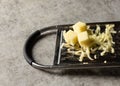 Grated Parmesan cheese, Cheese grater with cheddar Royalty Free Stock Photo