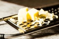 Grated Parmesan cheese, Cheese grater with cheddar Royalty Free Stock Photo