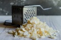 grated soap flakes piled beside a grater for homemade laundry Royalty Free Stock Photo