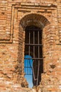 Grated window in old brick building Royalty Free Stock Photo