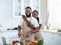 Grateful African American Woman Embracing Husband That Cooking Food In Kitchen