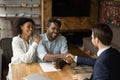 Grateful black family couple handshake with insurer before signing contract