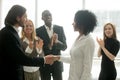 Grateful boss handshaking promoting african businesswoman congra Royalty Free Stock Photo