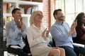 Smiling diverse coworkers applaud thanking for seminar speech