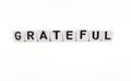 grateful word built with white cubes and black letters on white background