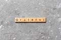 Grateful word written on wood block. Grateful text on table, concept