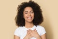 Grateful young african american happy sincere woman. Royalty Free Stock Photo