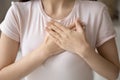 Grateful young woman applying hands on chest, expressing love