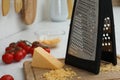 Grater, cheese and cherry tomatoes on kitchen counter, closeup Royalty Free Stock Photo